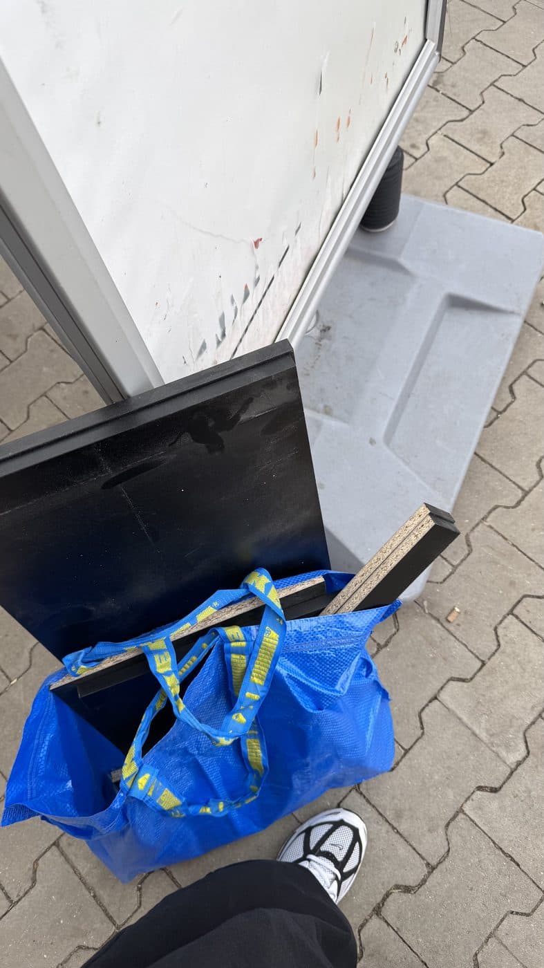 Cut panels in a plastic bag on the pavement outside.